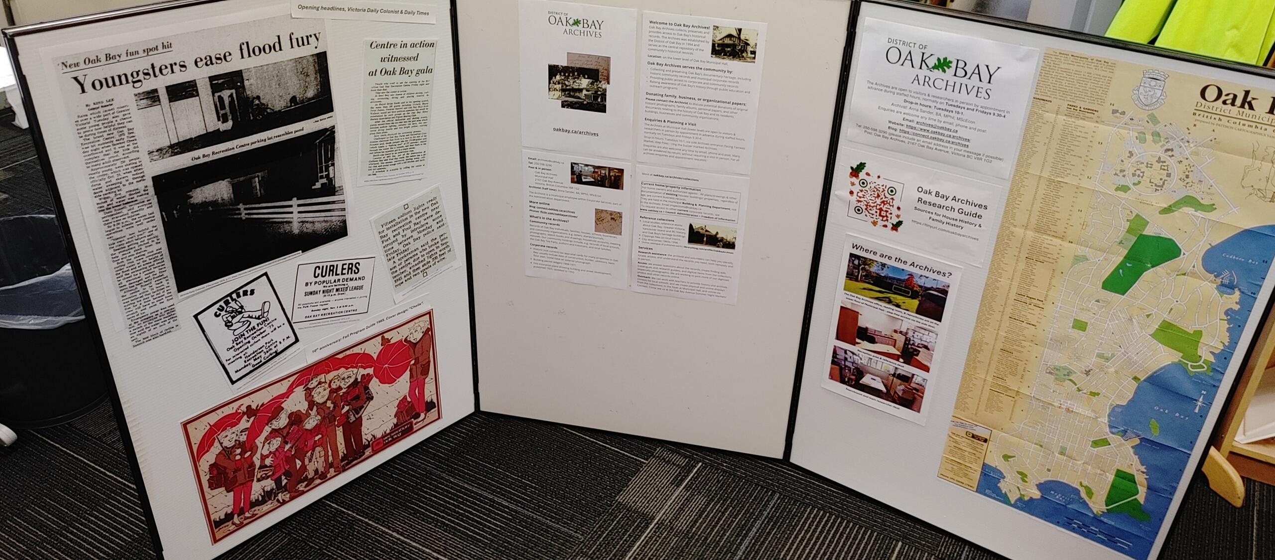Three display boards featuring historical articles, community information, and a map of Oak Bay Archives.